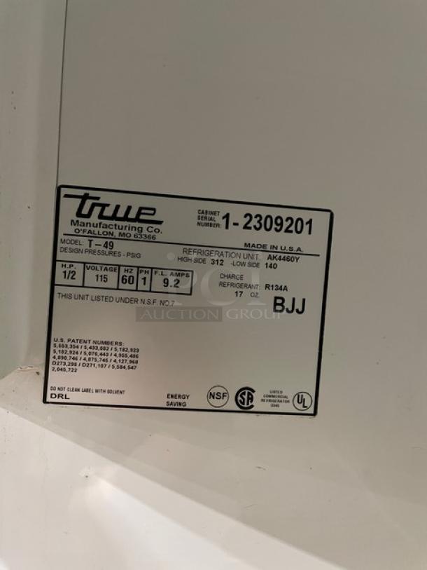 True T-49 stainless steel 2-door reach-in refrigerator with poly-coated racks, model T-49, serial 1-2309201, on casters.