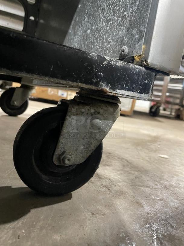 True T49 commercial refrigerator caster detail, showing sturdy wheel for mobility. Model T-49, SN: 1-2309201.