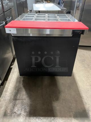 Continental SW32-12M black single door prep table with stainless steel top, red cutting board, food pans, and wire rack.