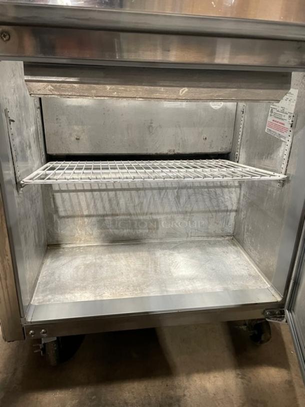 Continental Commercial Black Single Door Refrigerated Prep Table, Model SW3212M, with stainless steel worktop, red cutting board, clear food pans, poly-coated wire rack, and casters. Serial Number: 15768410. 115V 1 Phase.