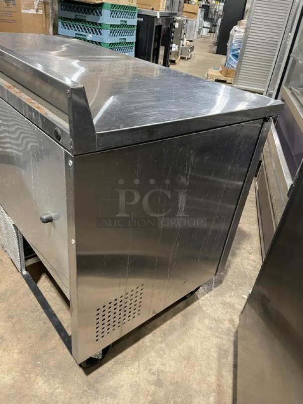 True TWT-60 stainless steel 2-door worktop refrigerator, Energy Star certified, with backsplash and poly-coated wire rack, on casters.