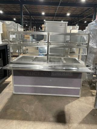 Atlas Metal stainless steel 4-well cold salad bar, Model WCMBT4, with sneeze guard, tray slide, and enclosed storage.