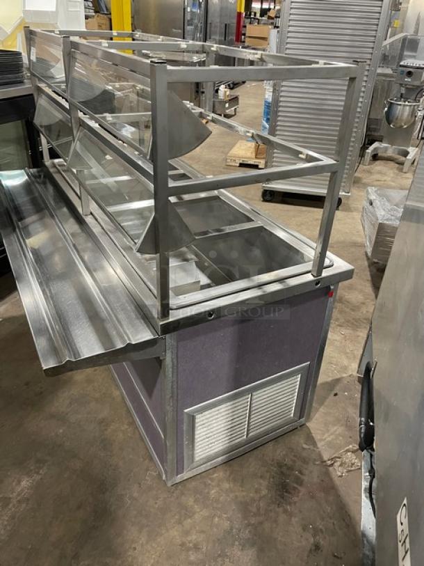 Atlas Metal refrigerated 4-well salad bar with sneeze guard, tray slide, enclosed storage, model WCMBT4, on casters.