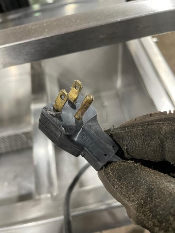 Atlas Metal stainless steel refrigerated buffet salad bar plug, showing 115V plug prongs. Model WCMBT4, serial 848-0.