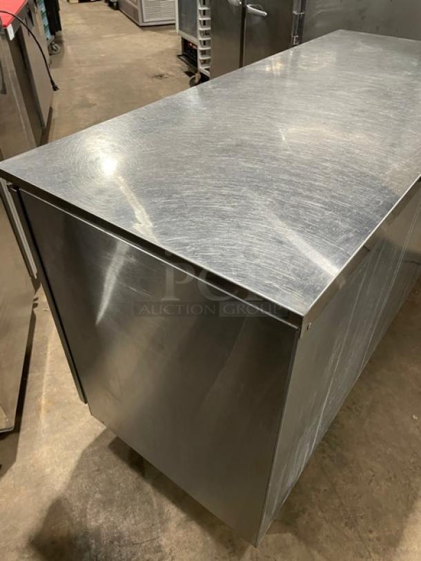 GlasTender stainless steel 2-door back bar cabinet, Model LP60L6SSLL, with poly-coated rack, on legs, in good condition.
