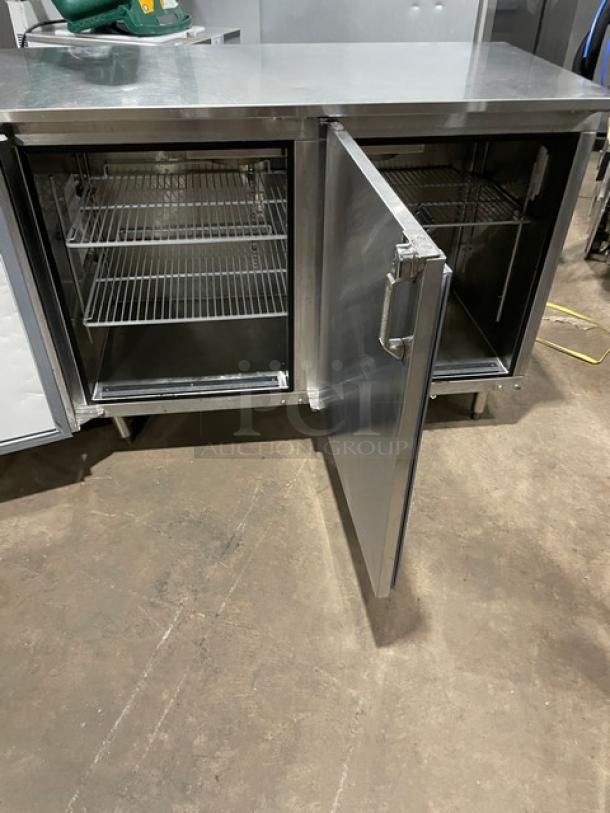 GlasTender stainless steel 2-door low-profile back bar cabinet, Model LP60L6SSLL, with poly-coated racks, on legs, open door view.