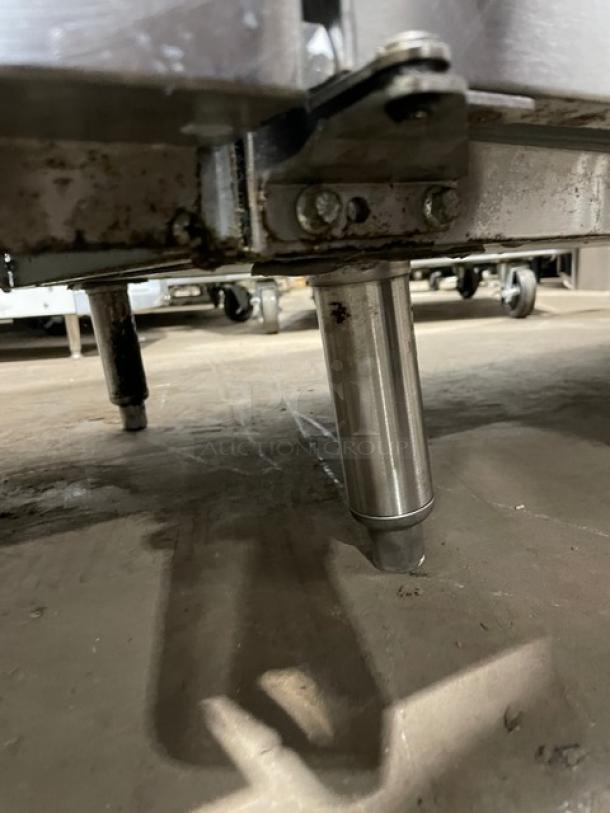 GlasTender LP60L6SSLL commercial stainless steel back bar cabinet leg. In used condition, shows signs of wear. Model and serial numbers not visible.