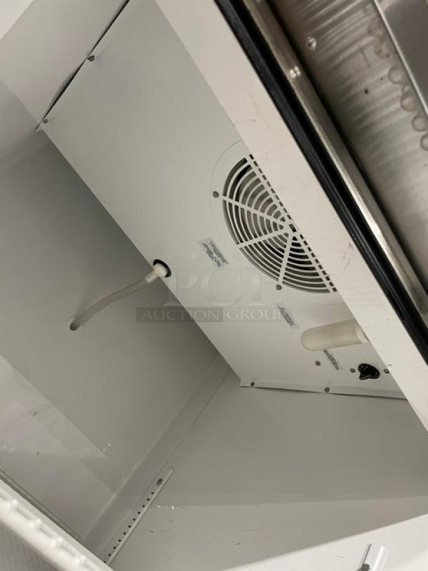 True T-23 commercial refrigerator interior with Energy Star certification, poly-coated rack, and visible fan.