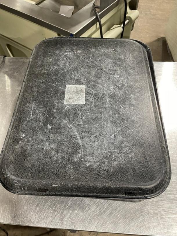 Black rectangular serving tray with textured surface, used condition. Measures approximately 16xYour Bid size.