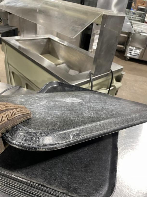 Commercial black rectangular fast food serving tray stack, visible scuff marks, durable plastic, 16X bid value.