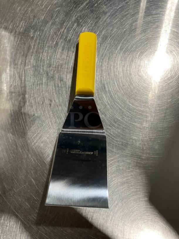 Brand new Dexter Russell 4"x3" hamburger turner, Sani-Safe Series, stainless steel with yellow grip handle, Model S286-4.