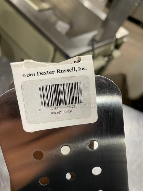 Brand new Dexter Russell 8"x3" perforated cake turner, model P94857, stainless steel with black grip handle, barcode tag visible.