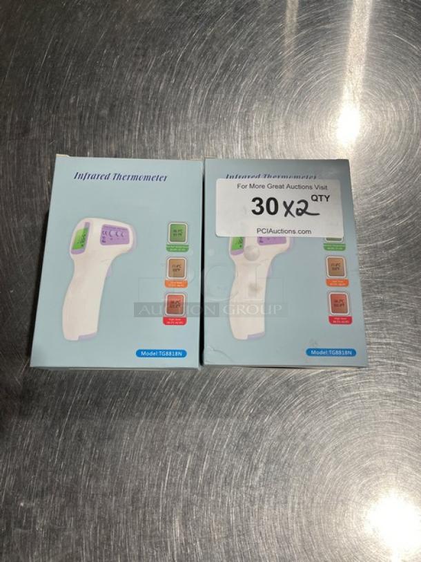 Brand new TG8818N infrared non-contact forehead thermometers in original packaging; model visible on box. Quantity: 2.