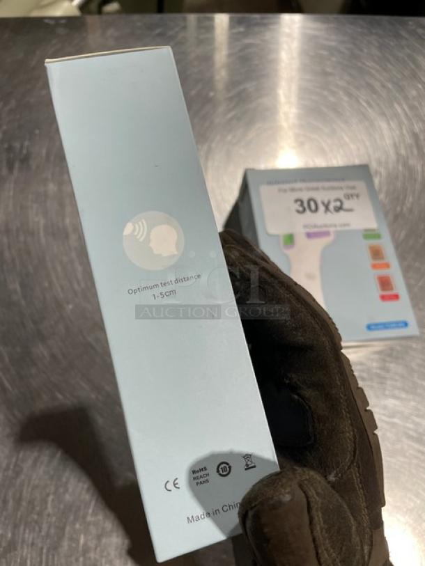 Brand new TG8818N infrared non-contact forehead thermometer, packaging indicates optimum test distance of 1-5 cm, CE certified.
