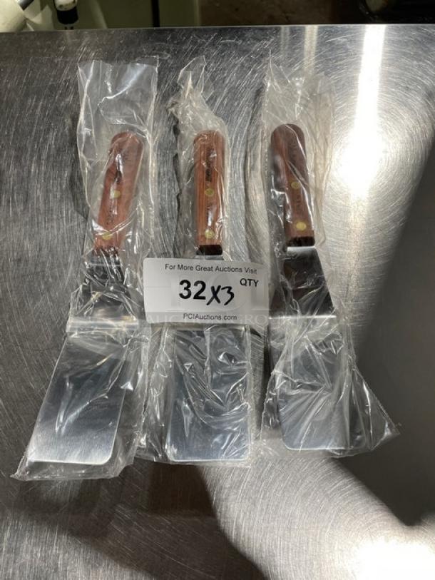 Dexter Russell stainless steel pancake turner, model S25412, with wooden handle, new condition, set of three.