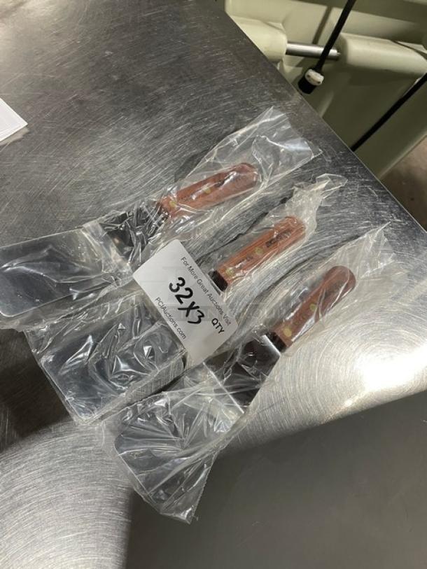 Dexter Russell stainless steel pancake turners, model S25412, with wooden grip handles in original packaging. Quantity: 3.