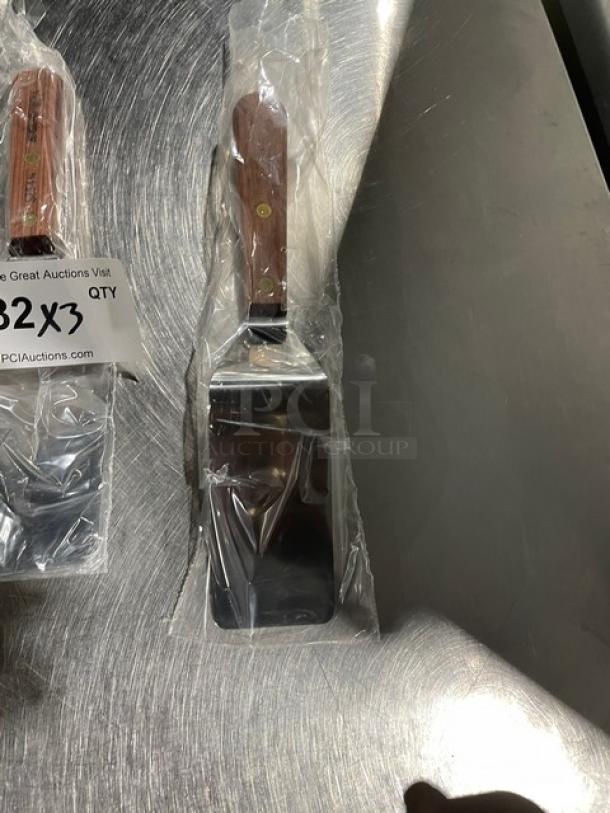Dexter Russell stainless steel pancake turner, model S25412, new in packaging. Features 4-1/4" x 2-1/8" blade, wooden handle.