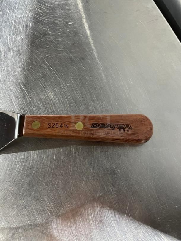 Dexter Russell stainless steel pancake turner, model S2541/2, with wooden grip handle. Brand and model marked on handle.