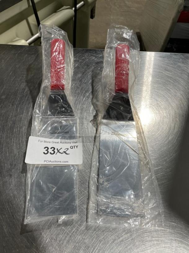 Brand new Dexter Russell Model 31989R stainless steel 8" x 3" turner with red grip handle in packaging.