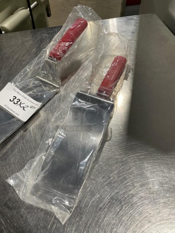 Dexter Russell Model 31989R stainless steel turner, 8" x 3" square edge, red grip handle, brand new in packaging.
