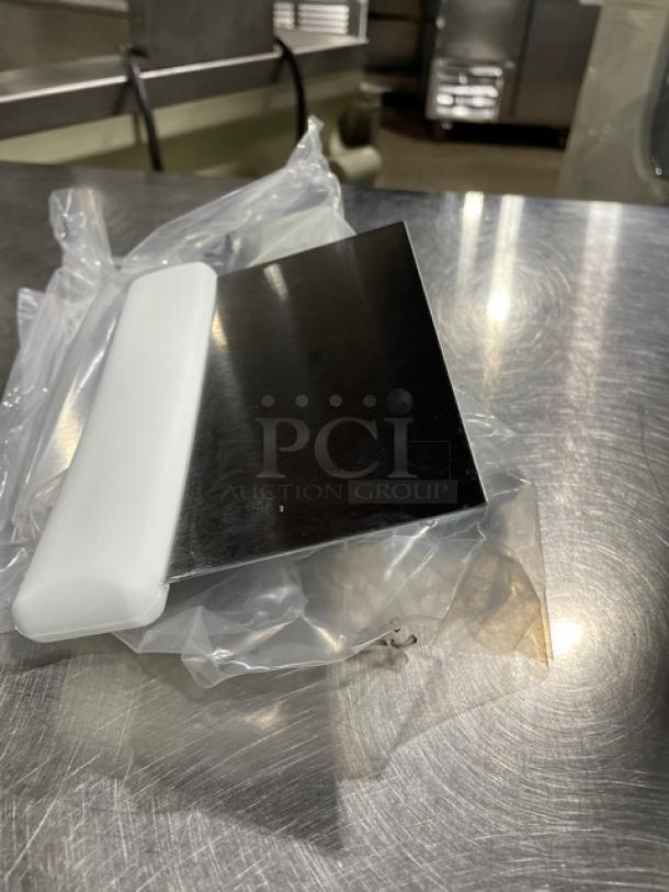 Stainless steel dough cutter with white grip handle, new condition. Packaged and ready for commercial use.