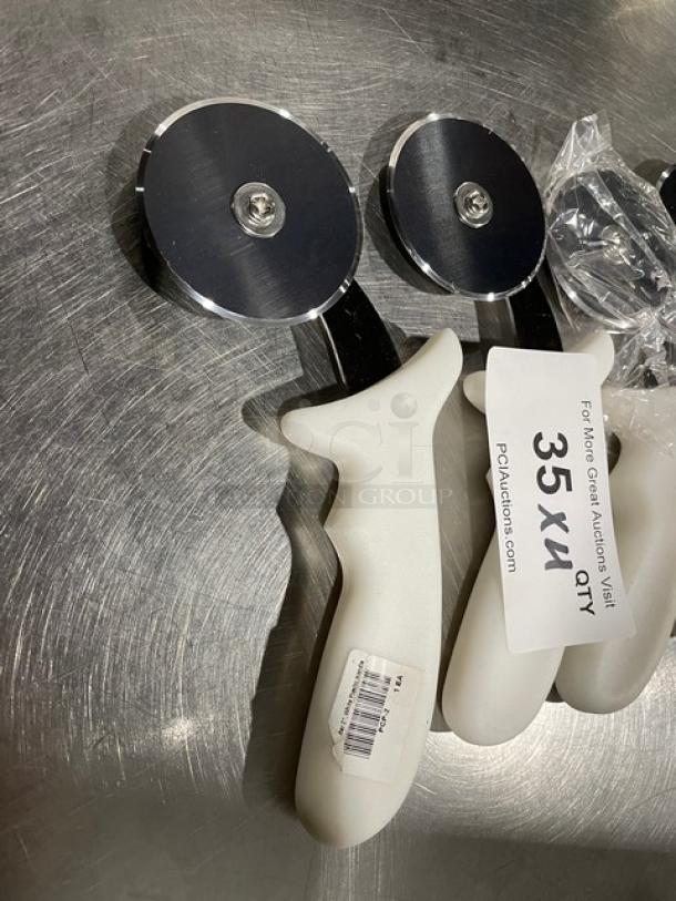 Brand new Dexter Russell stainless steel pizza cutter, 2-3/4" blade, white grip handle, model PCP-2, auction tag visible.