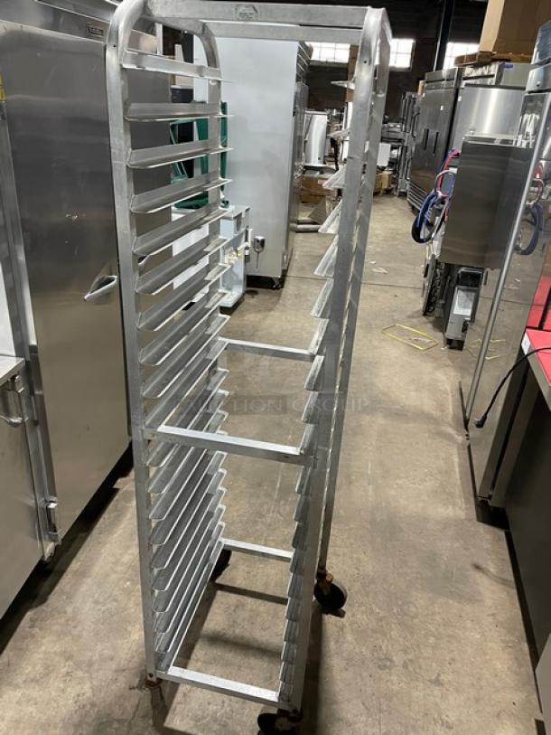 Commercial heavy duty pan holding/transport rack on casters, metal, multiple shelves, used condition, ideal for kitchen use.