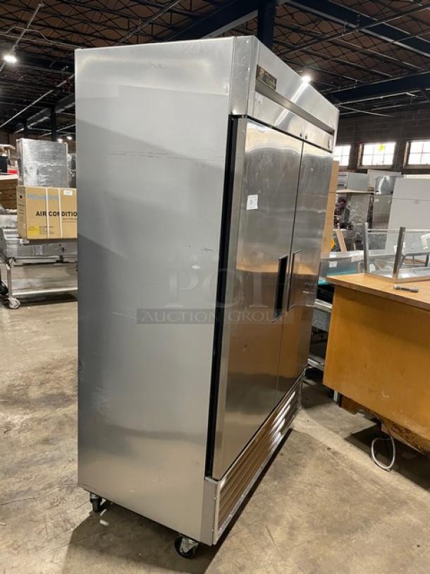 True T49F commercial stainless steel 2-door reach-in freezer, with poly coated wired racks, on casters, used condition.