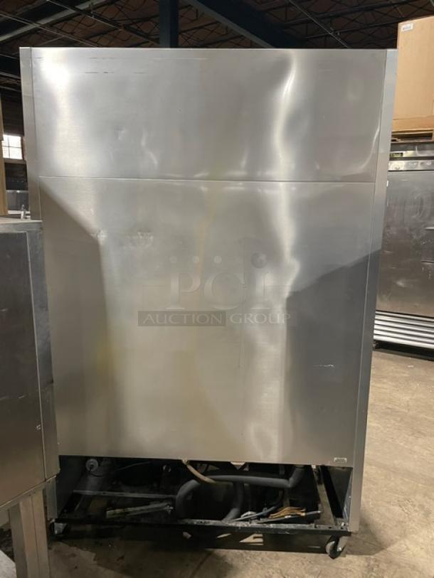 True T49F commercial stainless steel 2-door reach-in freezer, poly coated wired racks, model T-49F SN: 1-4032036, 115V, on casters.