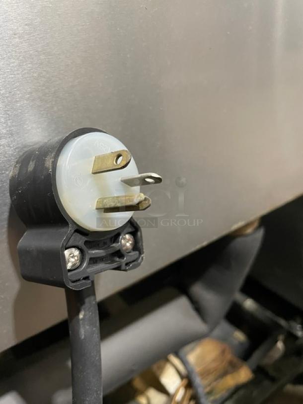 Close-up of plug for True T-49F stainless steel 2-door reach-in freezer, 115V, 1 phase, with poly coated wired racks, on casters.