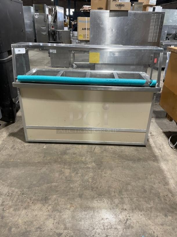 Atlas Metal stainless steel 4-well hot food steamtable with sneeze guard, tray slide, and casters, 208V 1 Phase, commercial use.
