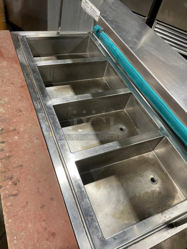 Atlas Metal stainless steel 4-well hot food steamtable with sneeze guard, tray slide, 208V, 1-phase, on casters.