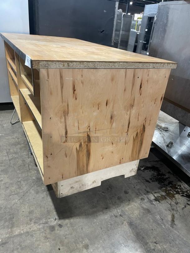 Custom commercial wooden cabinet base with multi-level shelving, enclosed style, in used condition, natural finish.