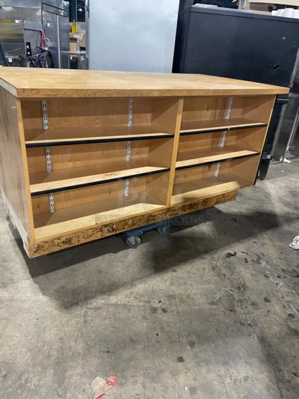Custom commercial wooden cabinet base with multi-level shelving, enclosed style, good condition. Ideal for storage.