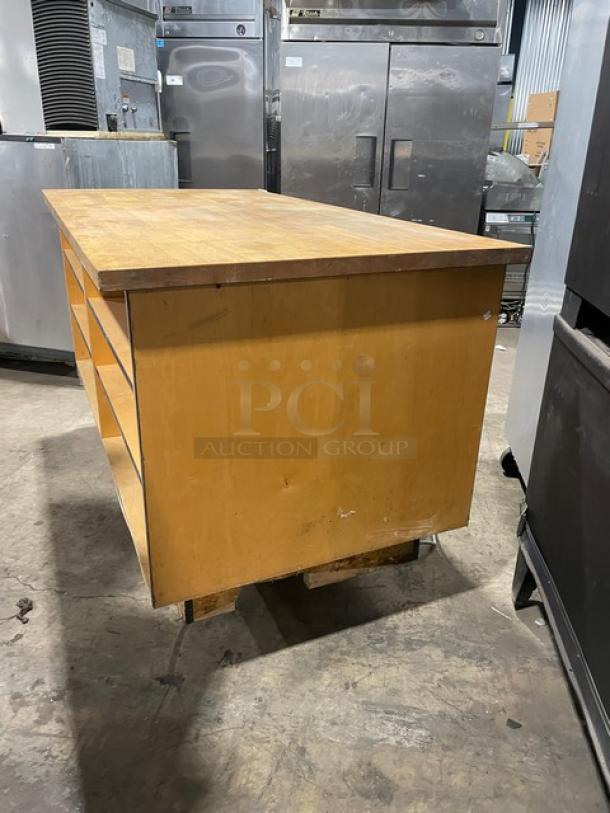 Custom commercial wooden enclosed cabinet base with multi-level shelving, natural finish, good condition. Ideal for storage.