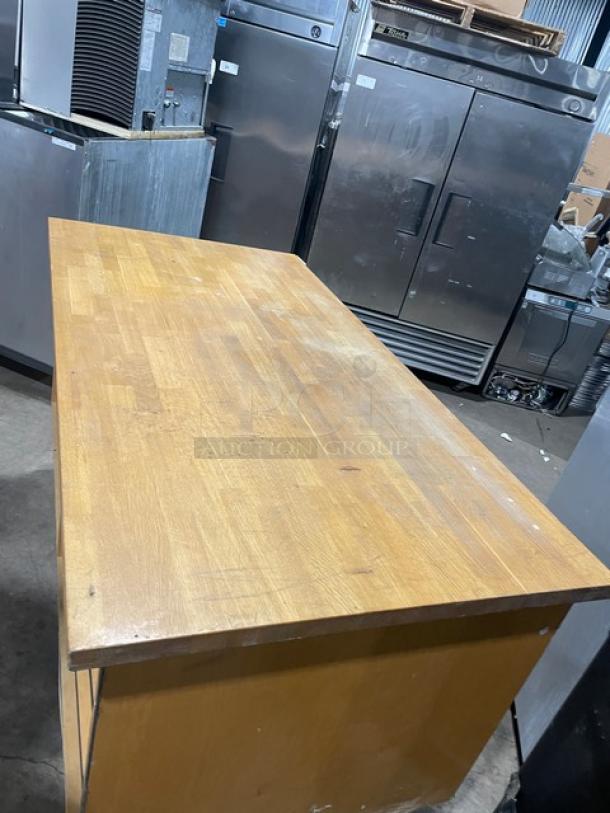 Custom commercial wooden cabinet base with multi-level shelving, enclosed style, good condition, natural wood finish.