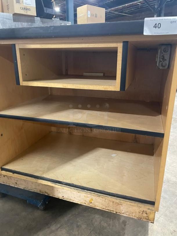 Custom commercial wooden cabinet base with multi-level shelving. Enclosed style, industrial wear, plywood build.