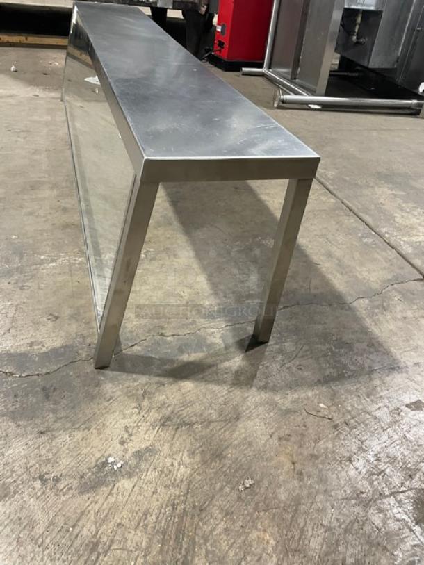 Commercial stainless steel serve over sneeze guard, in good condition, featuring clear glass panel, durable frame, ideal for food service.