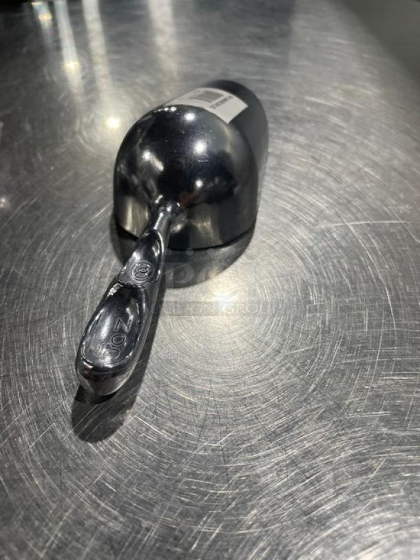 Commercial Cast Aluminum 5 oz. Handheld Scoop, Model ASC-05, in new condition. Marked "5 oz" on handle, shiny finish.