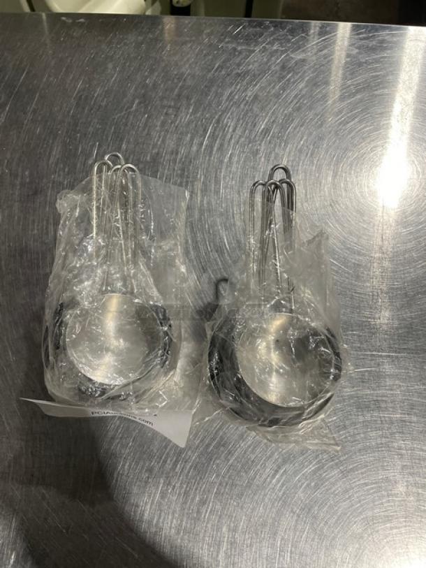 New commercial stainless steel measuring cup set in packaging, includes two sets of various sizes, pristine condition.