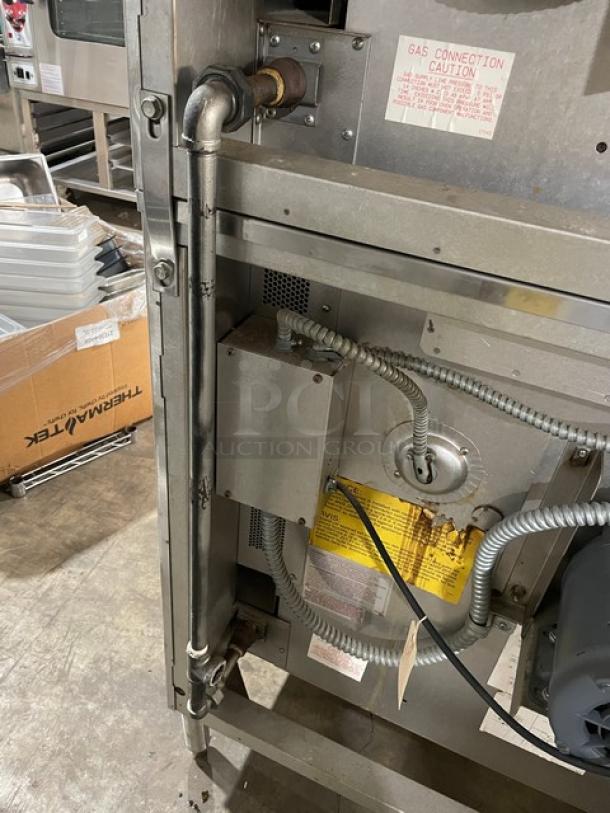Blodgett stainless steel double-stacked convection oven, natural gas, with solid-state thermostatic control and wired rack. On legs. Serial: 031203RA068T.