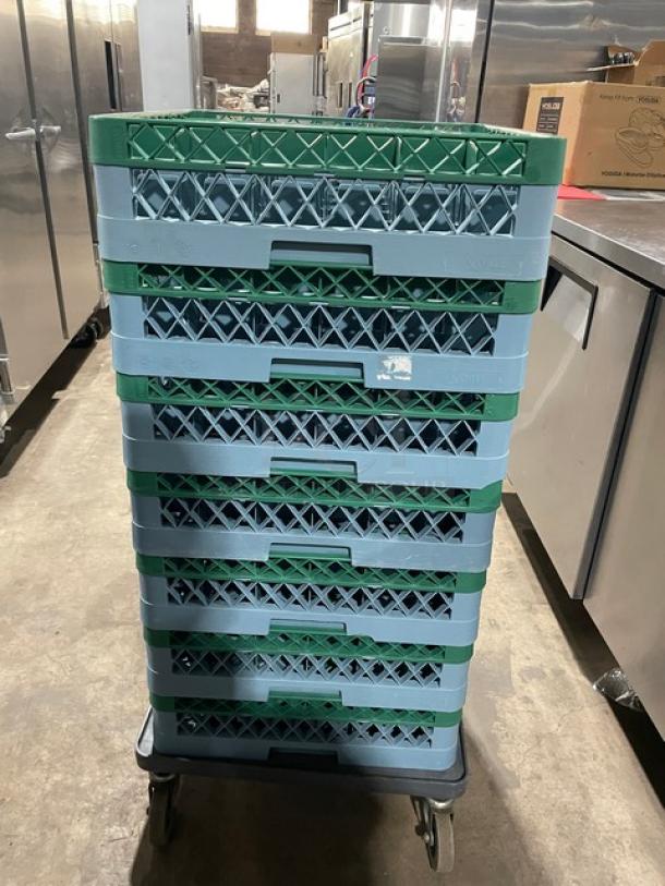 Blue full-size commercial cup rack with green extenders, stack of seven, on a wheeled base in a kitchen setting.