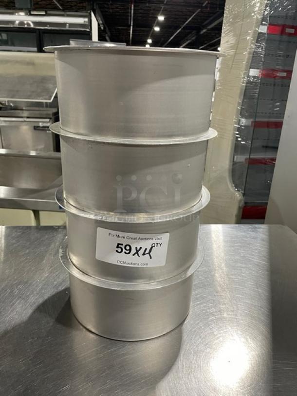Lot of four commercial round stock pots, stacked. Includes visible label "59XLP Qty" from PCI Auctions.