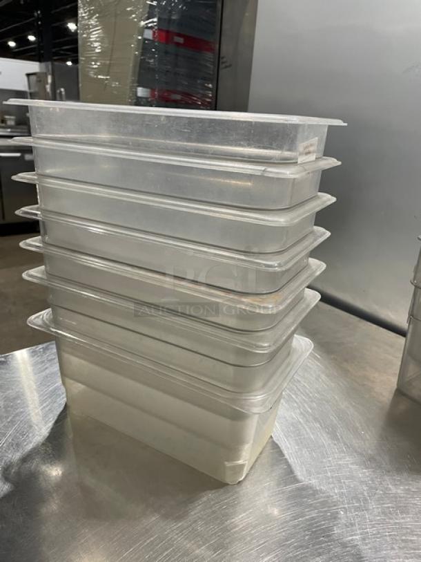 Cambro commercial clear polycarbonate food pans stacked. Seven items included, durable and versatile for food storage.