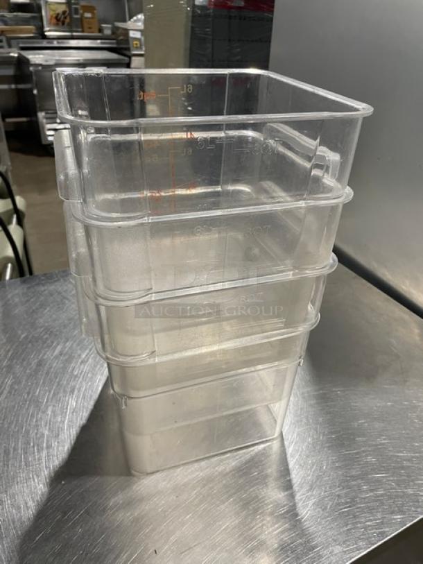 Winco 6 Qt. clear polycarbonate food storage containers, stack of four, marked with volume measurements, in good condition.