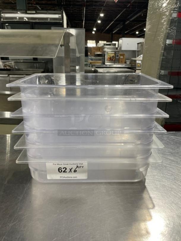 Stack of six commercial clear polycarbonate food pans. Label reads "62 x Qty," indicating bulk quantity. Auction item.