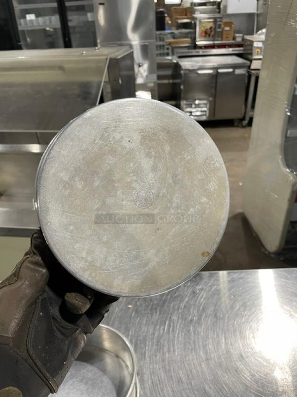 Commercial round baking/stacking pan, metal, used condition, visible logo stamp, ideal for bulk baking operations.