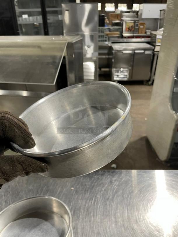 Commercial round baking/stacking pan in good condition, metallic finish. Ideal for professional kitchens.