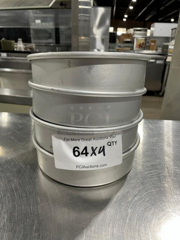 Commercial round baking pans, stack of four. Silver metal, good condition. Label reads "64X4 QTY, PCIAuctions.com."