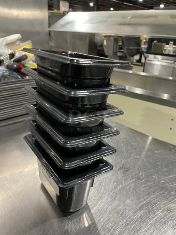 Vollrath commercial black food pans, stacked, in excellent condition. Durable plastic, suitable for professional kitchens.